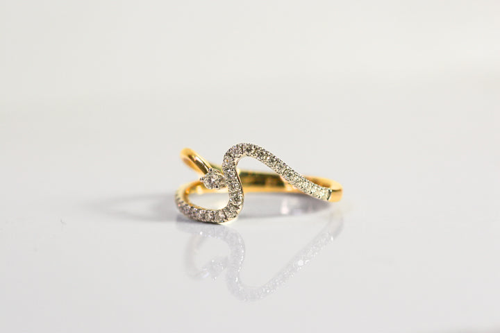 Wave ring. Diamonds all along the wave with a single round diamond floating next to the crest of the wave. Diamonds are set in white gold, while the rest of the ring is yellow gold. Local SF jewelry, San francisco, Luxury, hand made, Bay area, gift for her.