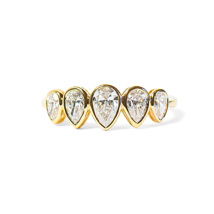 Gold ring with pear-shaped diamonds on a white background