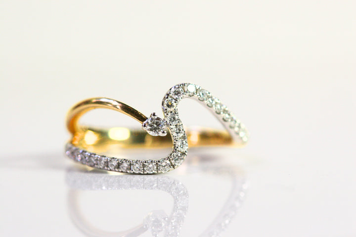 Wave ring. Diamonds all along the wave with a single round diamond floating next to the crest of the wave. Diamonds are set in white gold, while the rest of the ring is yellow gold. Local SF jewelry, San francisco, Luxury, hand made, Bay area, gift for her.