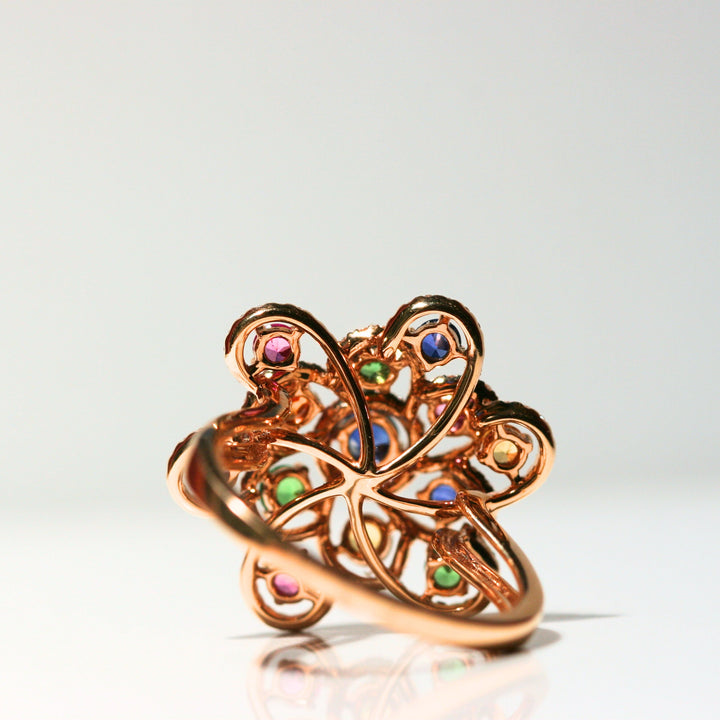 The back of the ring. There is a flat back of whirling rose gold to keep the ring comfortable. The band is made of solid rose gold and is simple. The back of each stone is free of metal, to allow maximum light to shine through.