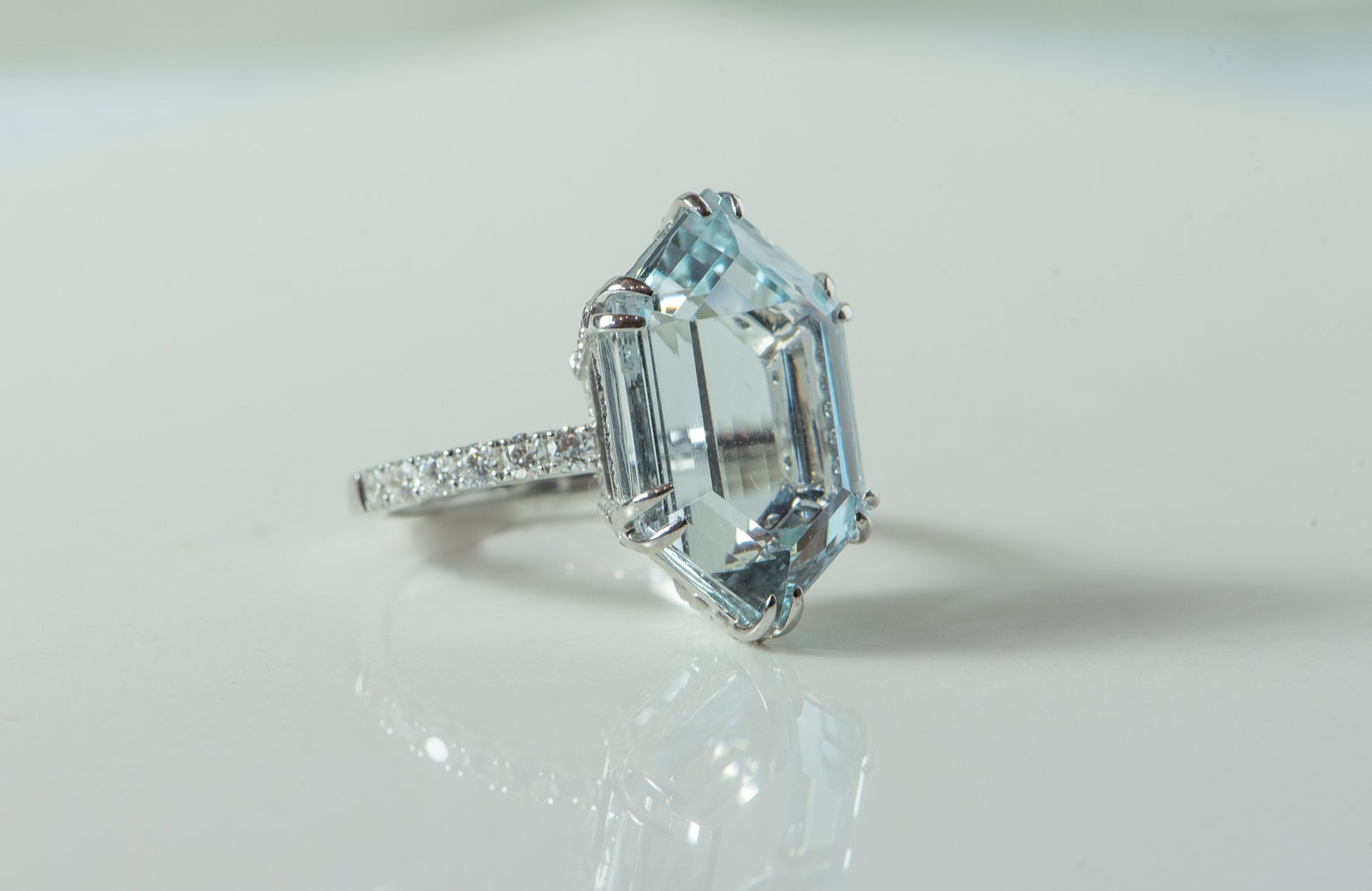 Aquamarine - step cut, hexagon. Set in white gold with diamonds.