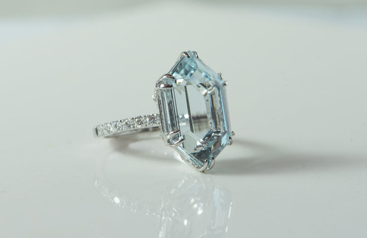 Aquamarine - step cut, hexagon. Set in white gold with diamonds.
