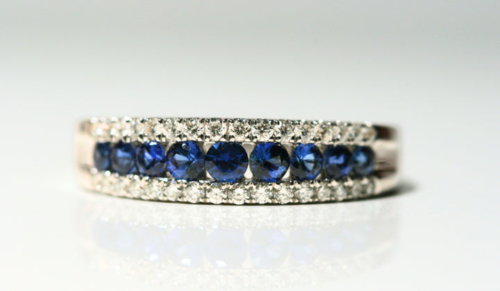 A close up of the front of the ring. Each sapphire is round and deep blue, and they are set between bands of diamonds on the top and bottom. Local SF jewelry, San francisco, Luxury, hand made, Bay area, gift for her, gift for him.