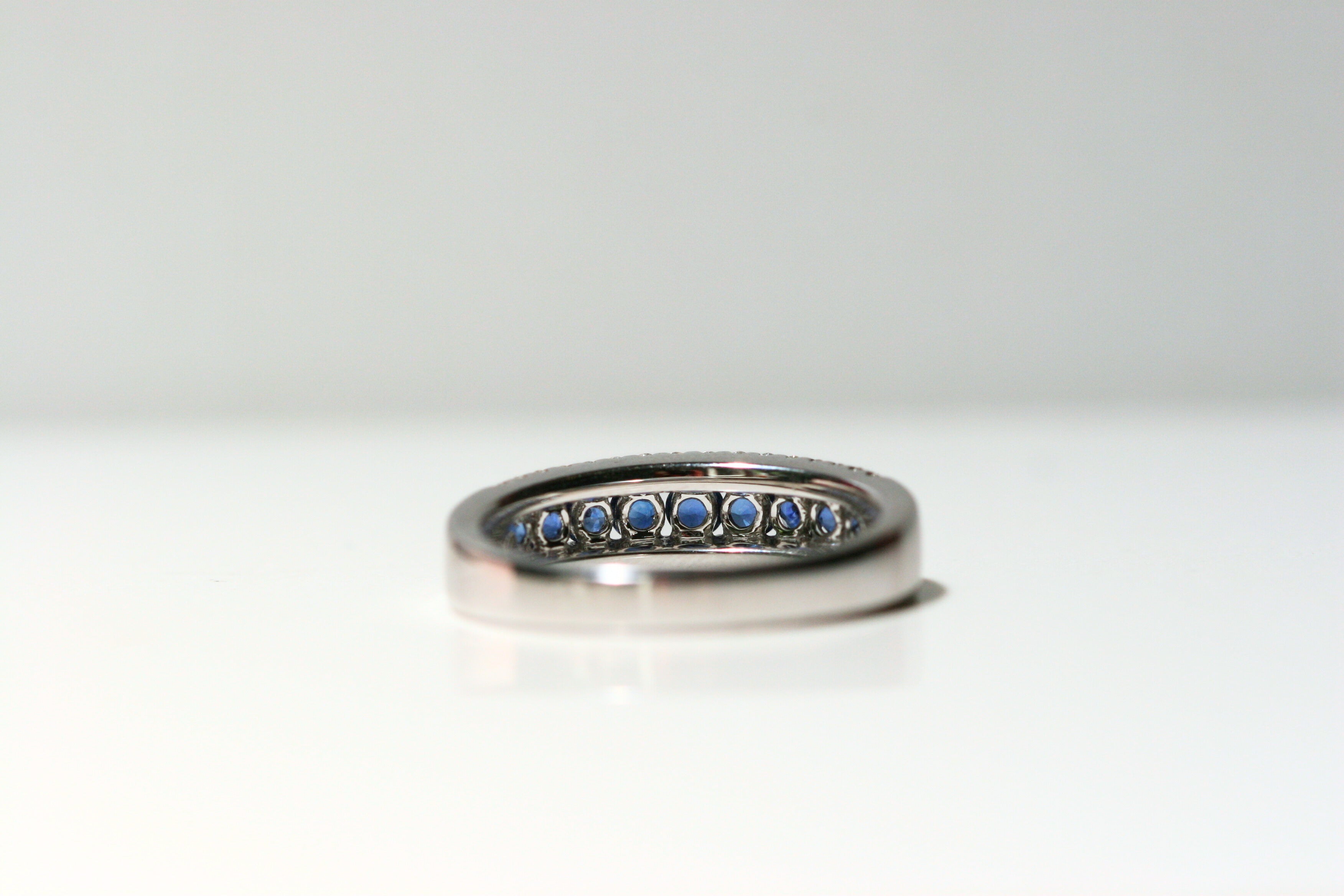 The back of the ring. The back of each sapphire is left open to allow maximum light in and create more sparkle. The back of the ring is solid white gold. Local SF jewelry, San francisco, Luxury, hand made, Bay area, gift for her, gift for him.