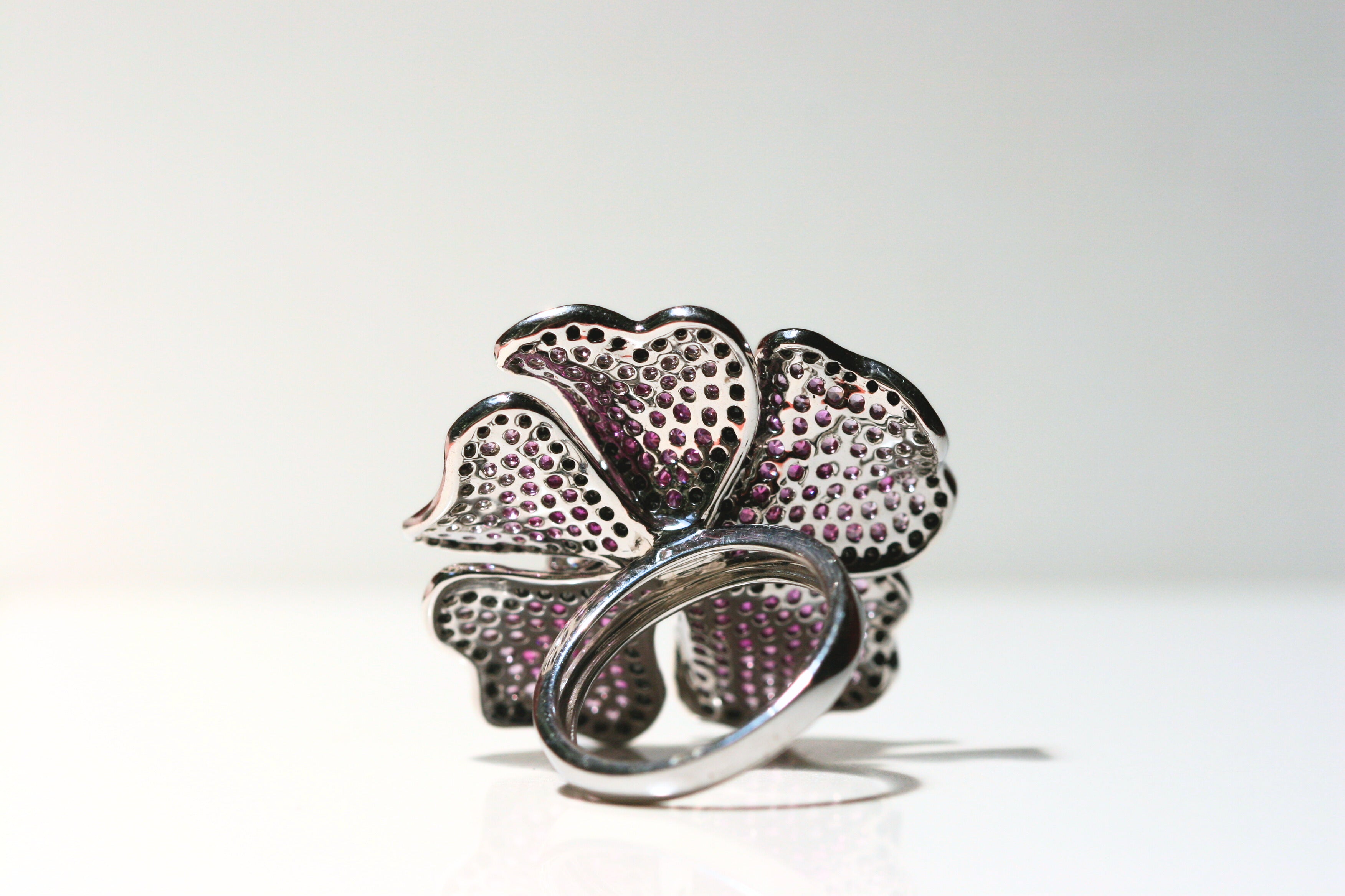 The back of the ring. Made of 18k white gold. The band is solid gold and the same thickness all the way around. The back of each petal has holes to allow maximum light to reach the stones. Local SF jewelry, San francisco, Luxury, hand made, Bay area, gift for her, september birthstone