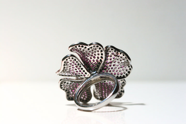 The back of the ring. Made of 18k white gold. The band is solid gold and the same thickness all the way around. The back of each petal has holes to allow maximum light to reach the stones. Local SF jewelry, San francisco, Luxury, hand made, Bay area, gift for her, september birthstone