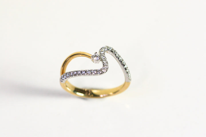 Wave ring. Diamonds all along the wave with a single round diamond floating next to the crest of the wave. Diamonds are set in white gold, while the rest of the ring is yellow gold. Local SF jewelry, San francisco, Luxury, hand made, Bay area, gift for her.