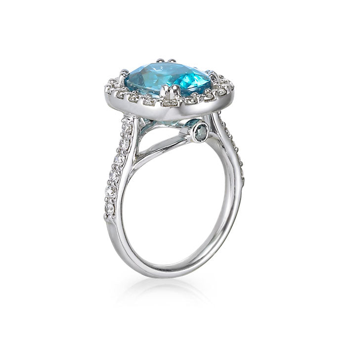 blue zircon ring. oval cut. blue gemstone turquoise gemstone. diamond halo. princess diana ring. diamond and white gold ring. colored gemstone. engagement ring. cocktail ring. statement ring. december birthstone. SF jewelry, local jeweler, luxury, fine jewelry, bay area, handmade, gift for her, birthday gift, anniversary gift