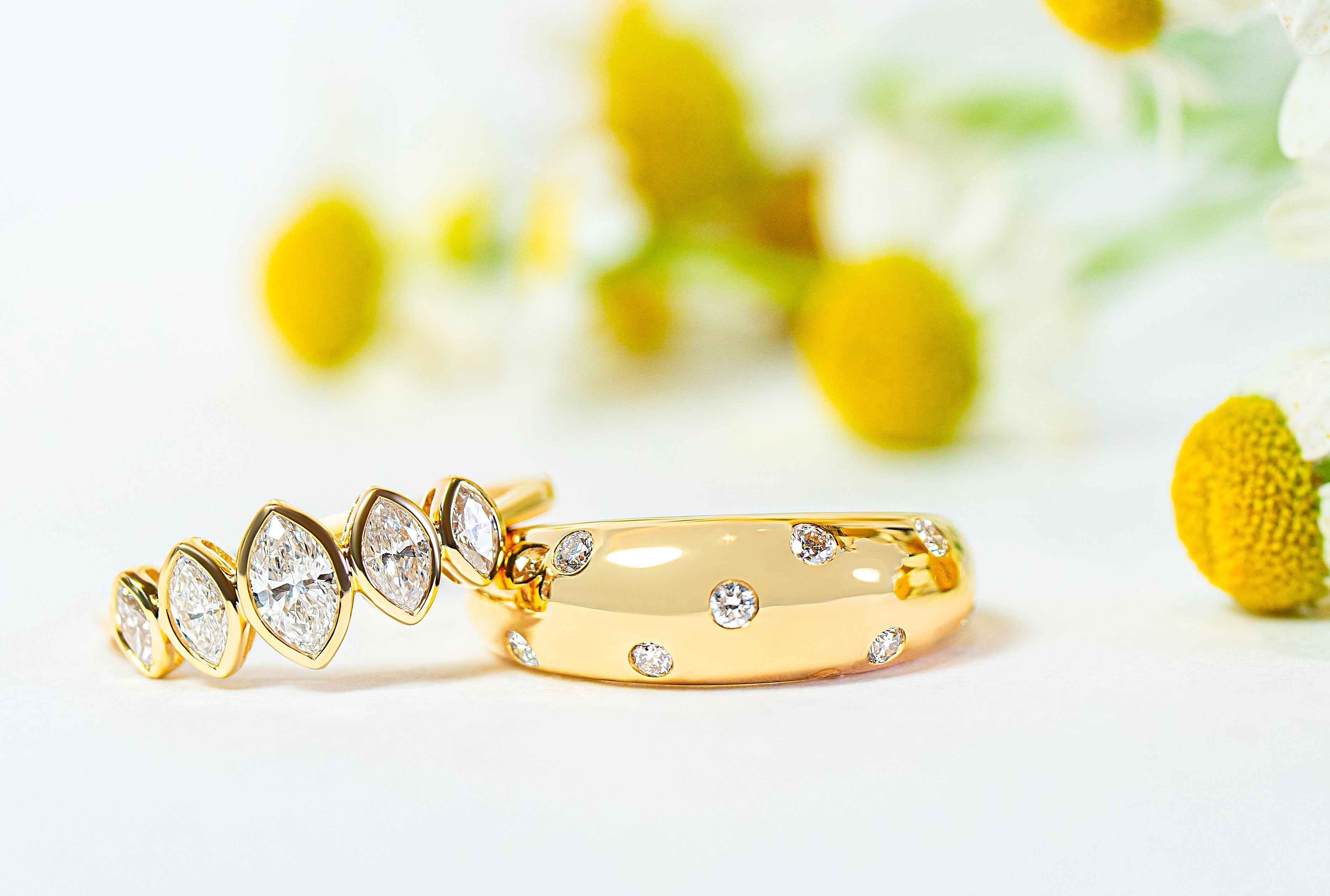 bezel graduated marquise diamond ring  in yellow gold with polka dot diamond cigar ring in yellow gold  