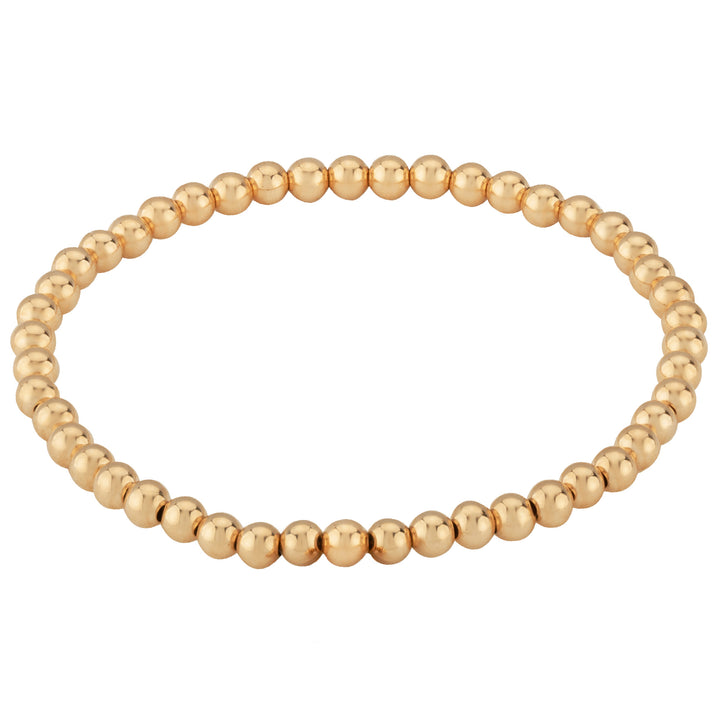 Gold beaded bracelet on a white background