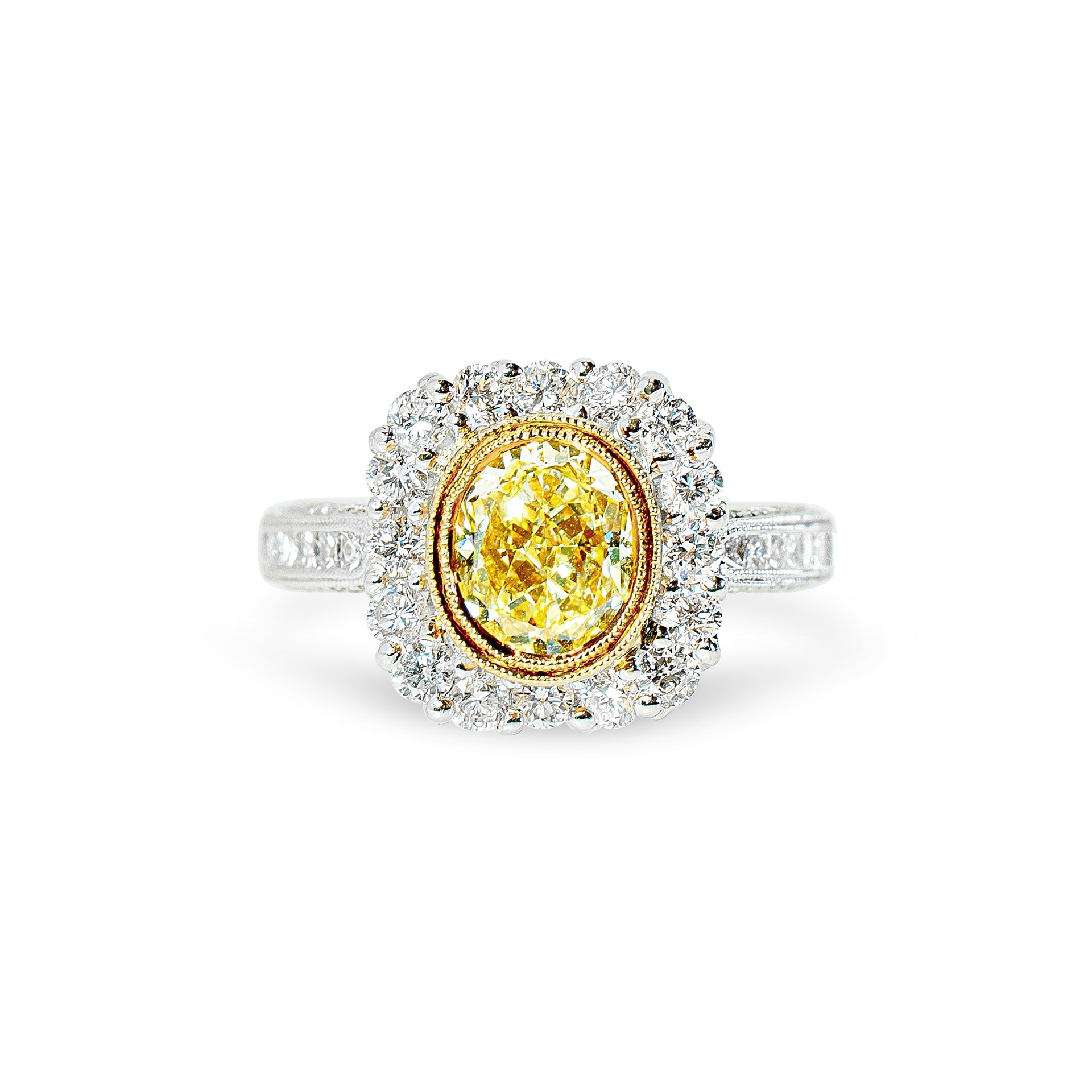 Ring with a yellow diamond and diamond halo on a white background