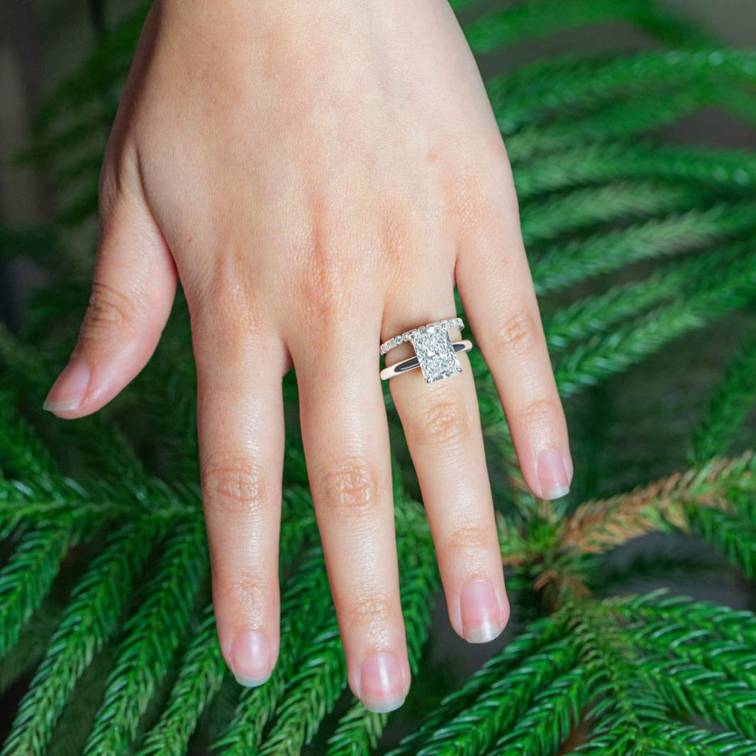 "Fay" Round and Princess cut diamond band with milgrain detail in 18k white gold stacked with engagement ring on hand  