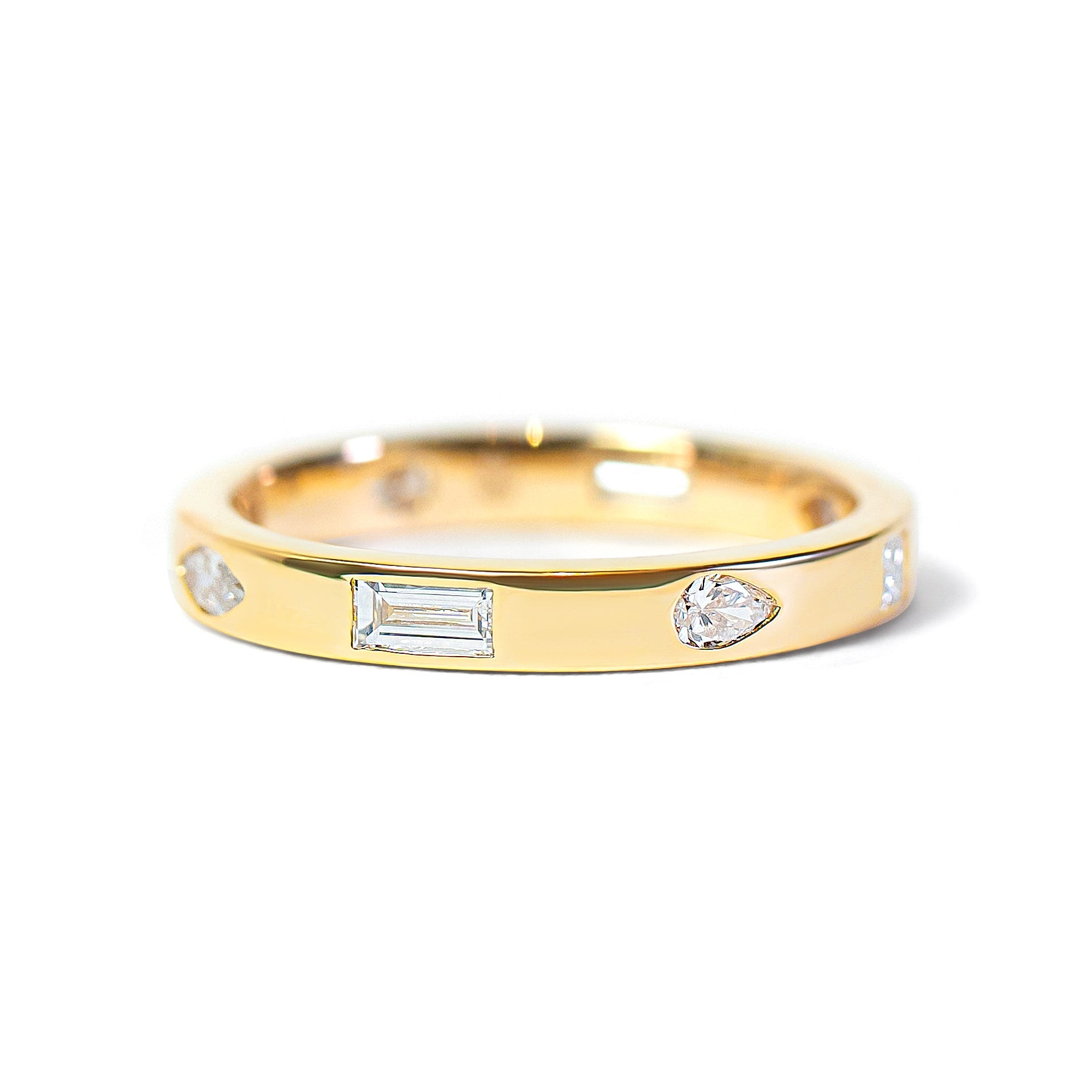 Gold ring with embedded mix-shaped diamonds on a white background