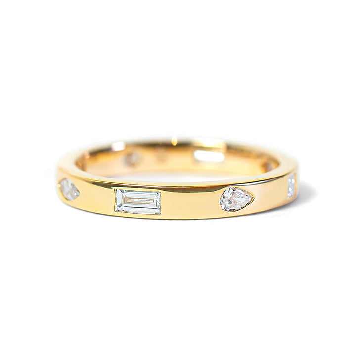 Gold ring with embedded mix-shaped diamonds on a white background