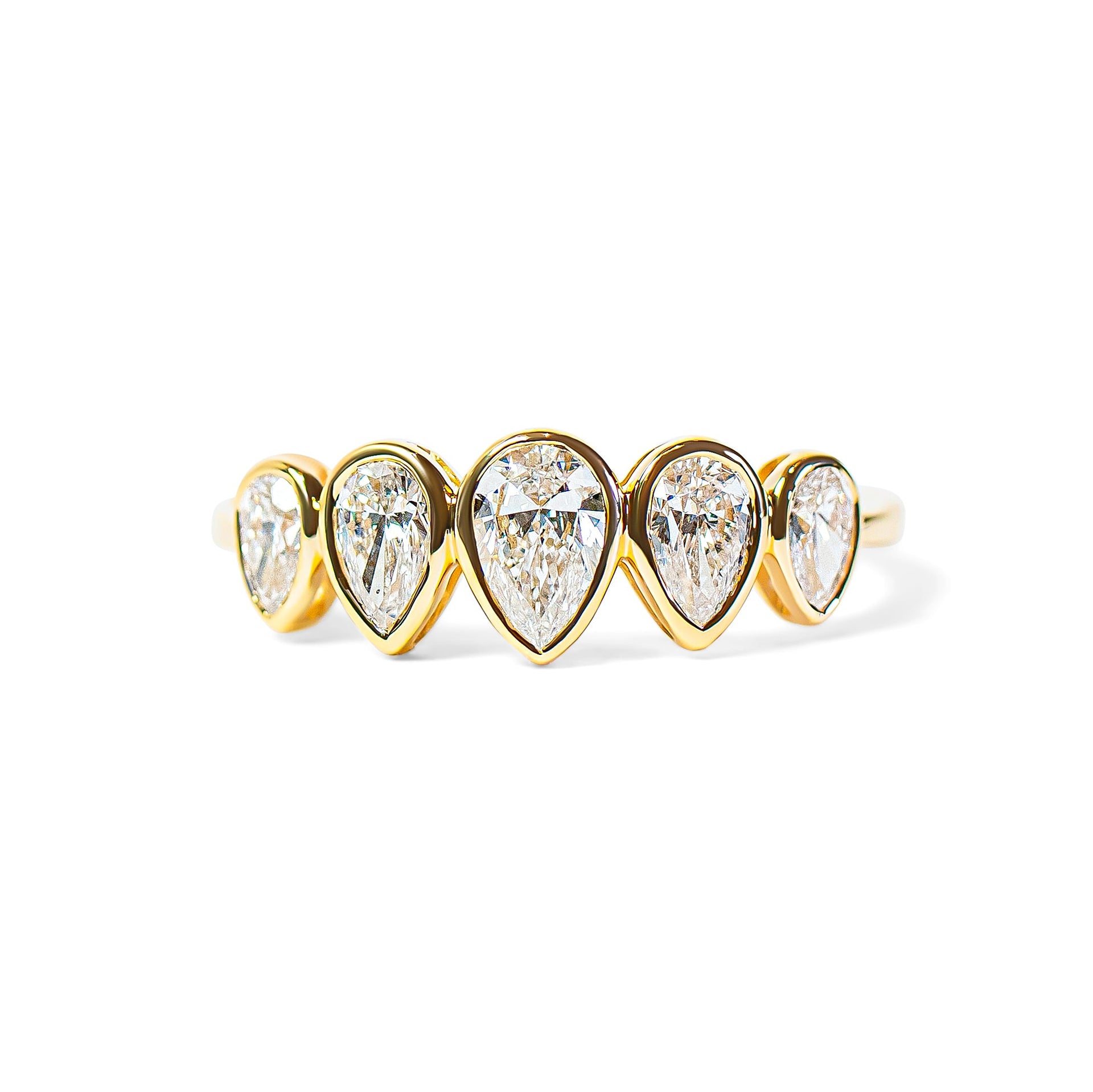 Gold ring with pear-shaped diamonds on a white background