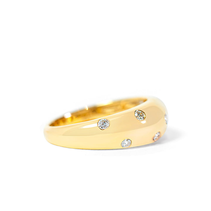 Gold ring with embedded diamonds on a white background
