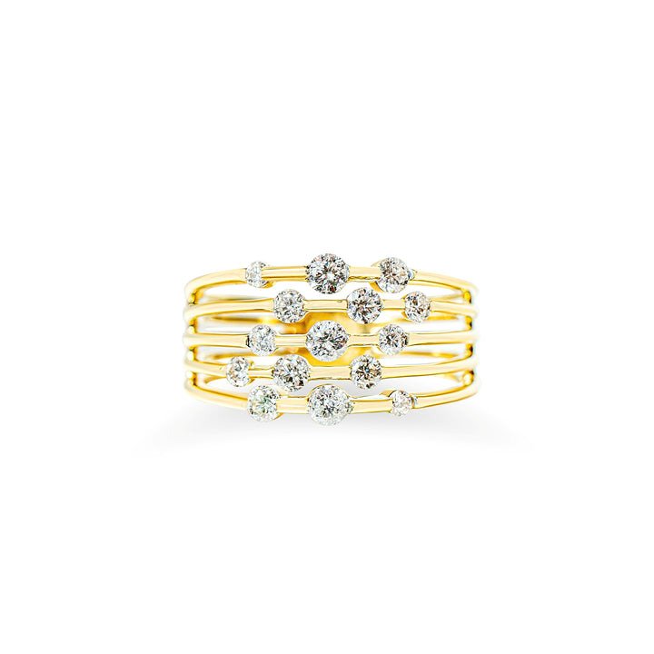 A gold multi-band ring featuring a central arrangement of scattered round brilliant cut diamonds, photographed against a solid white background.