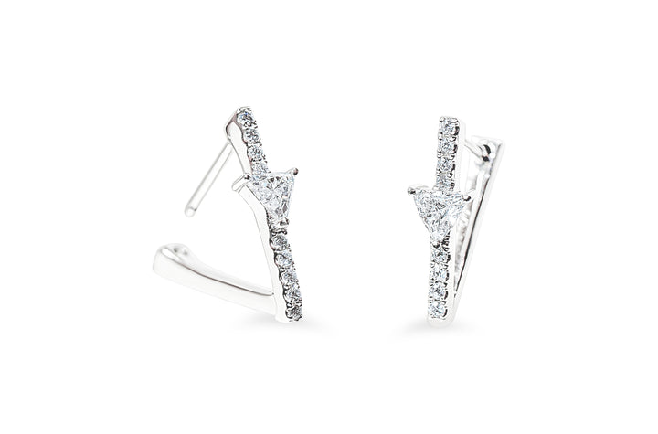 A pair of white-gold geometric hoop earrings with triangular diamonds and pavé round diamonds, shown on a clean white background.