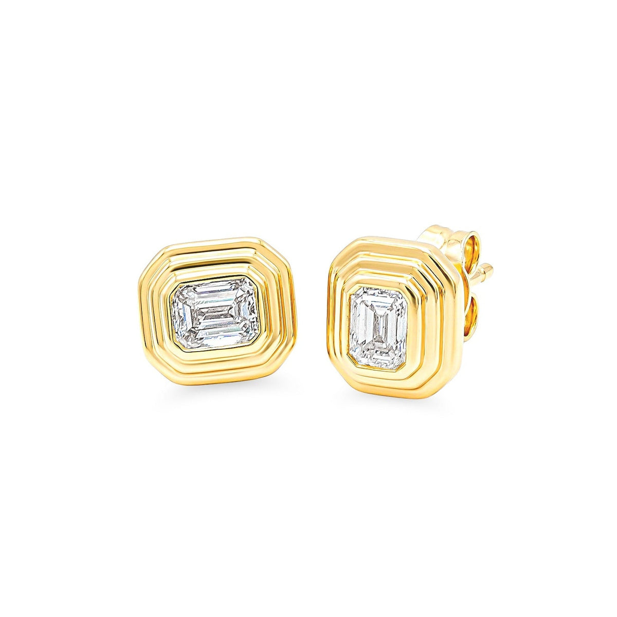 A pair of gold geometric stud earrings with bezel-set emerald-cut diamonds, displayed on a clean white background.