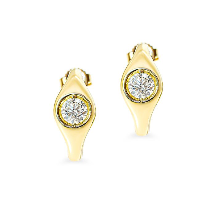 A pair of gold crescent-shaped stud earrings with a single round diamond flush set in the center, displayed on a clean white background.