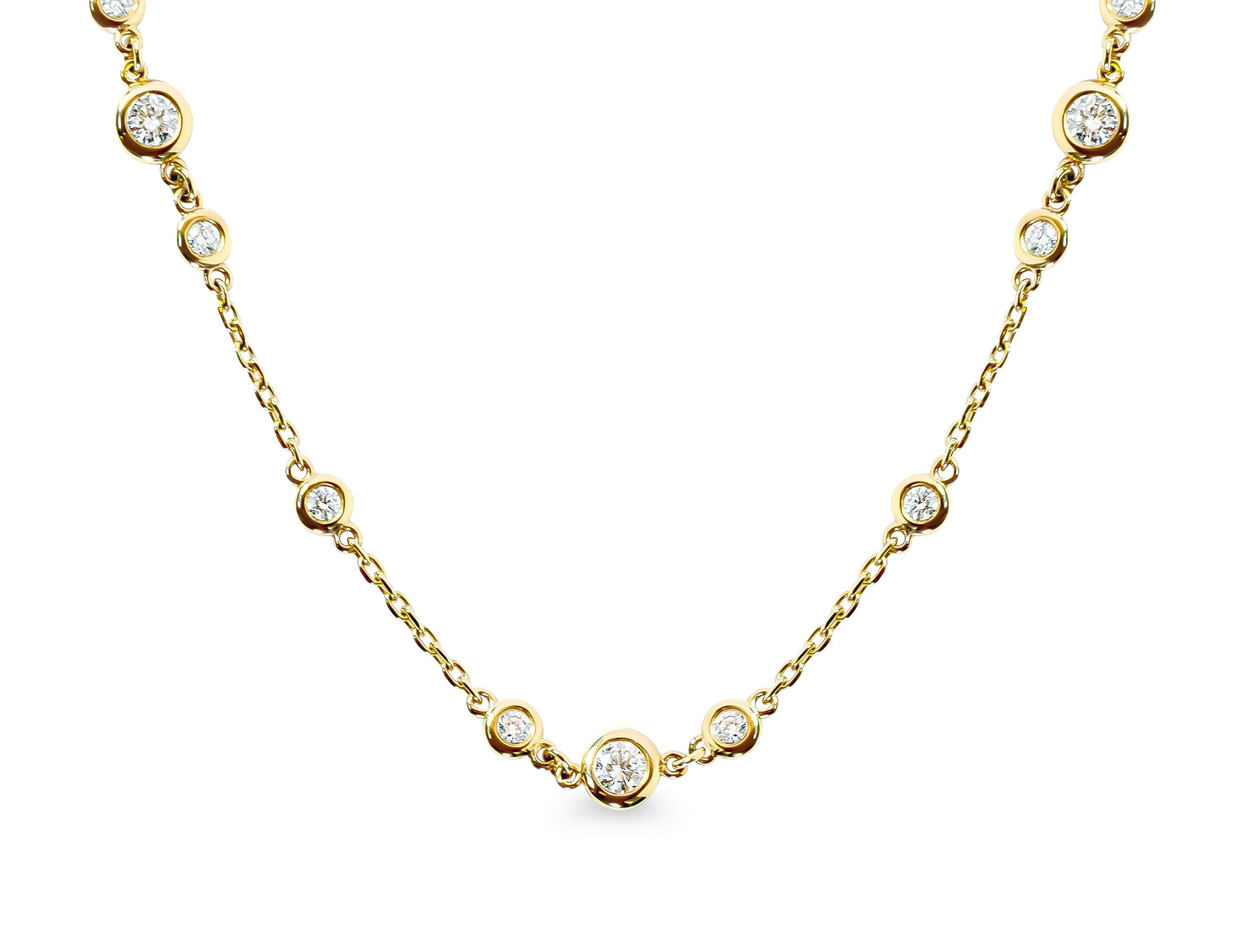 Gold necklace with small bezel-set diamonds on a white background