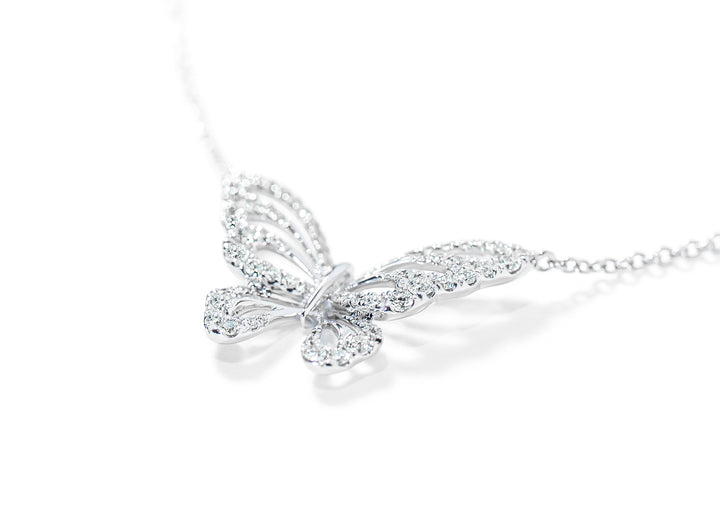 Butterfly-shaped diamond necklace on a white background