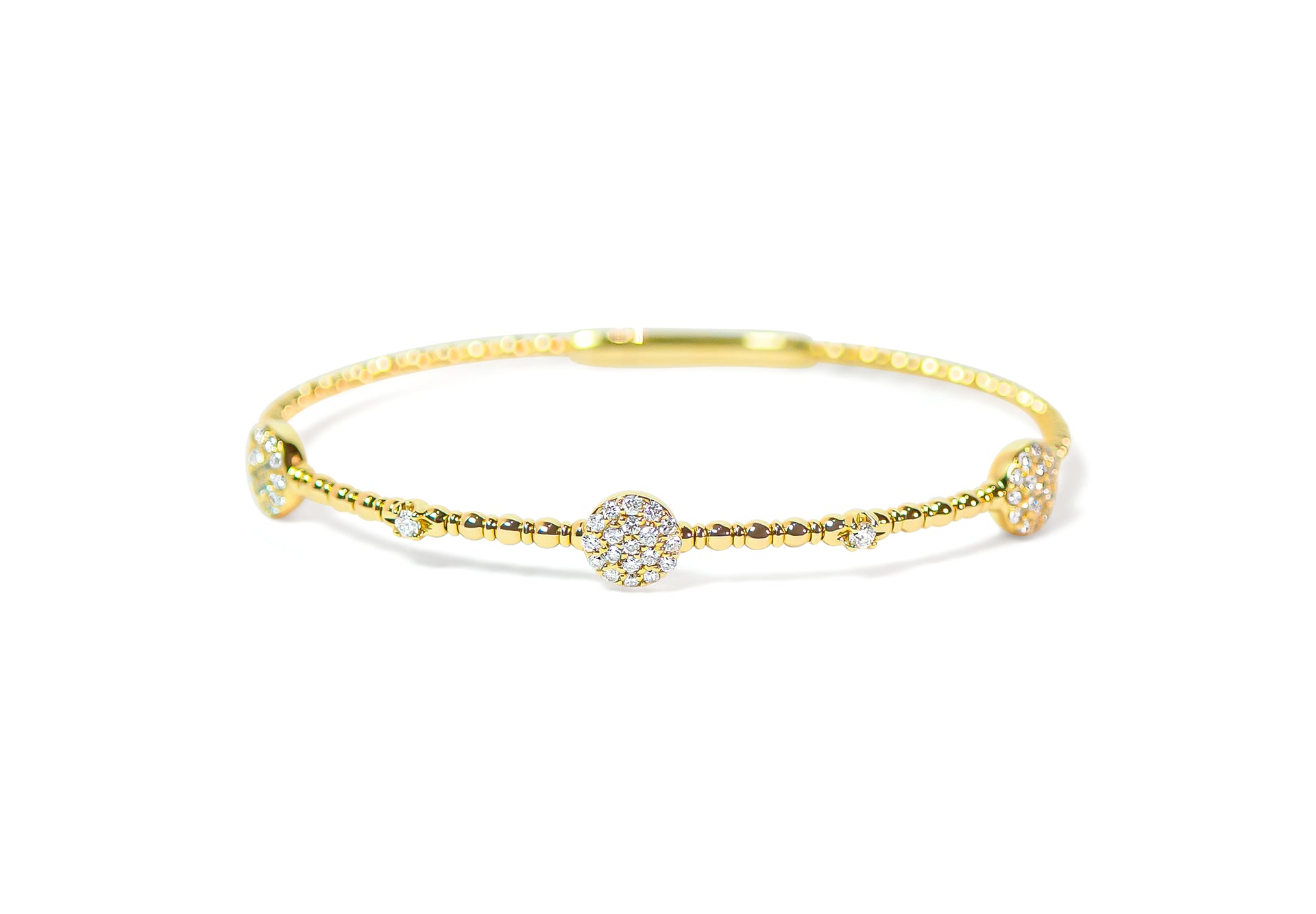 Gold bracelet with pave circle diamond accents on a white background