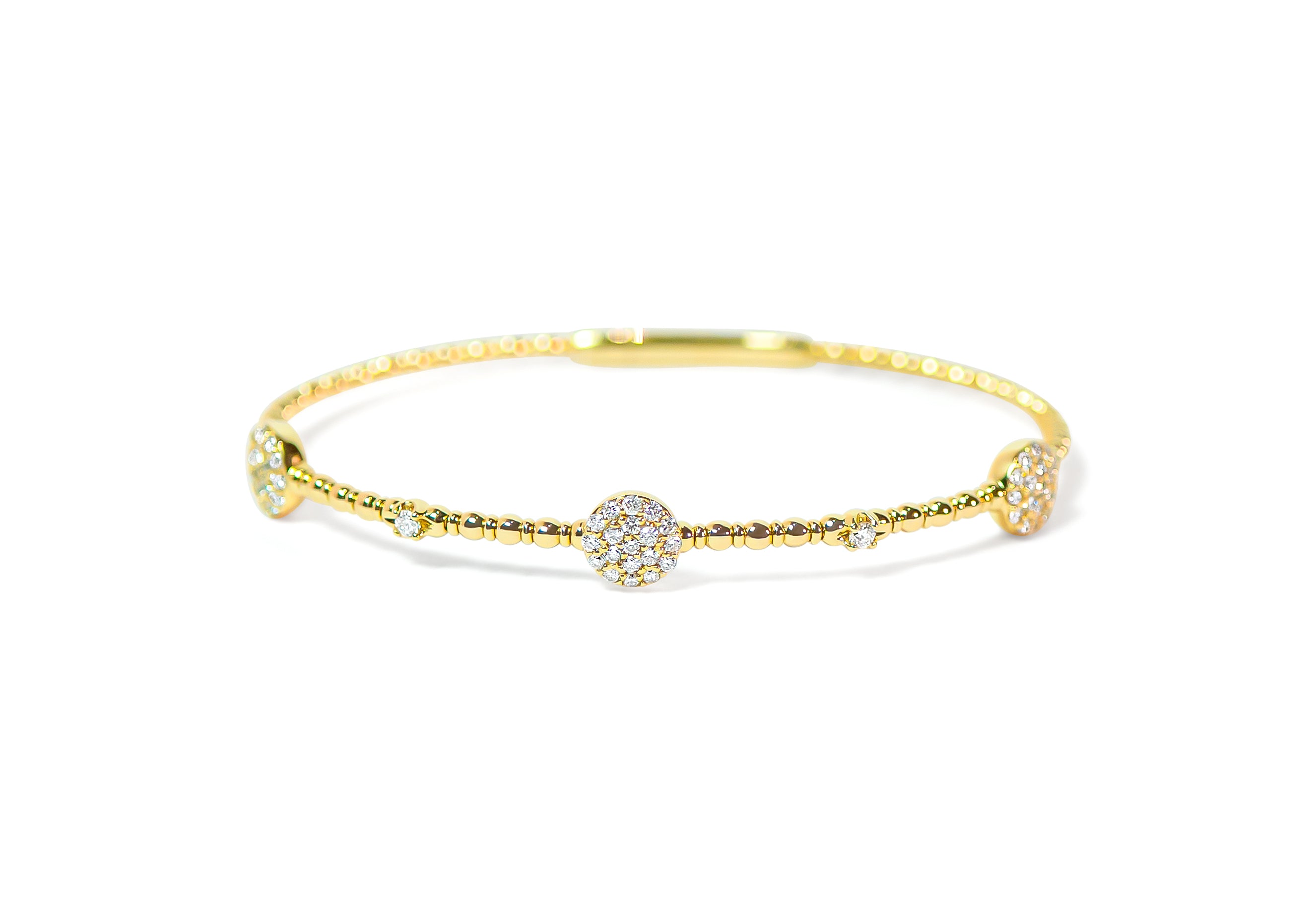 Gold bracelet with pave circle diamond accents on a white background