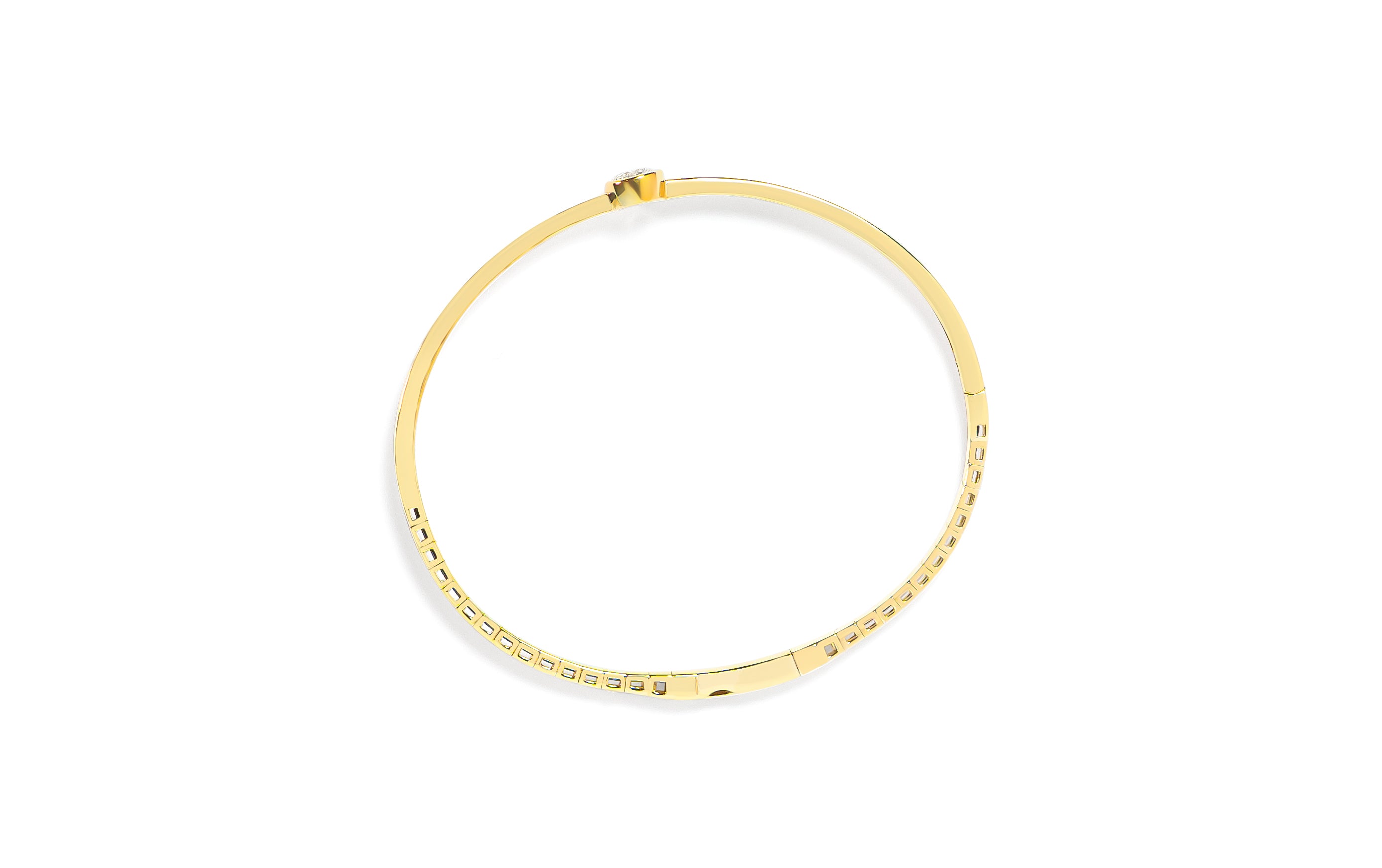 Top view of a gold bangle with a round diamond on a white background