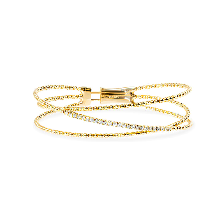 A delicate multi-strand gold wrap bangle featuring a diagonal row of delicate diamonds, displayed on a clean white background.