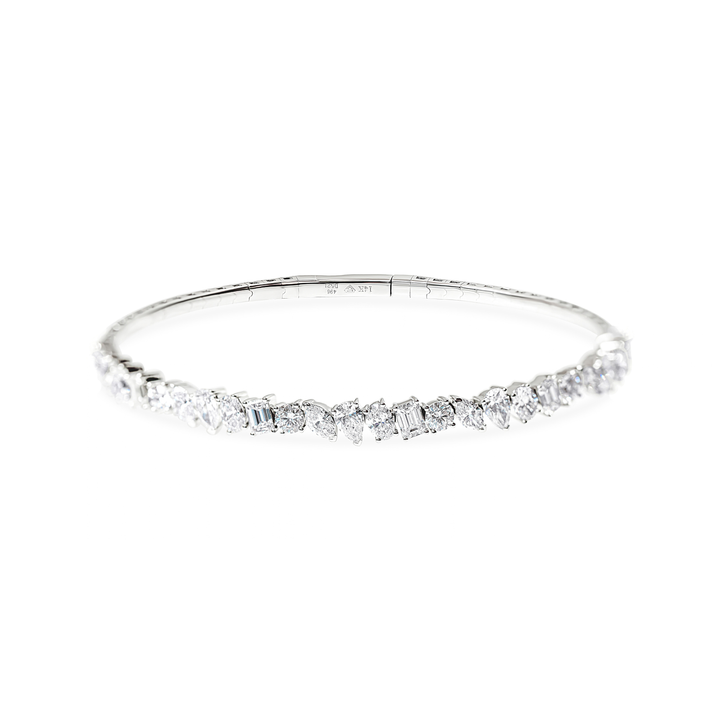A slim silver-toned bangle bracelet with a row of white mixed-cut diamonds across the front, shown on a plain white background.
