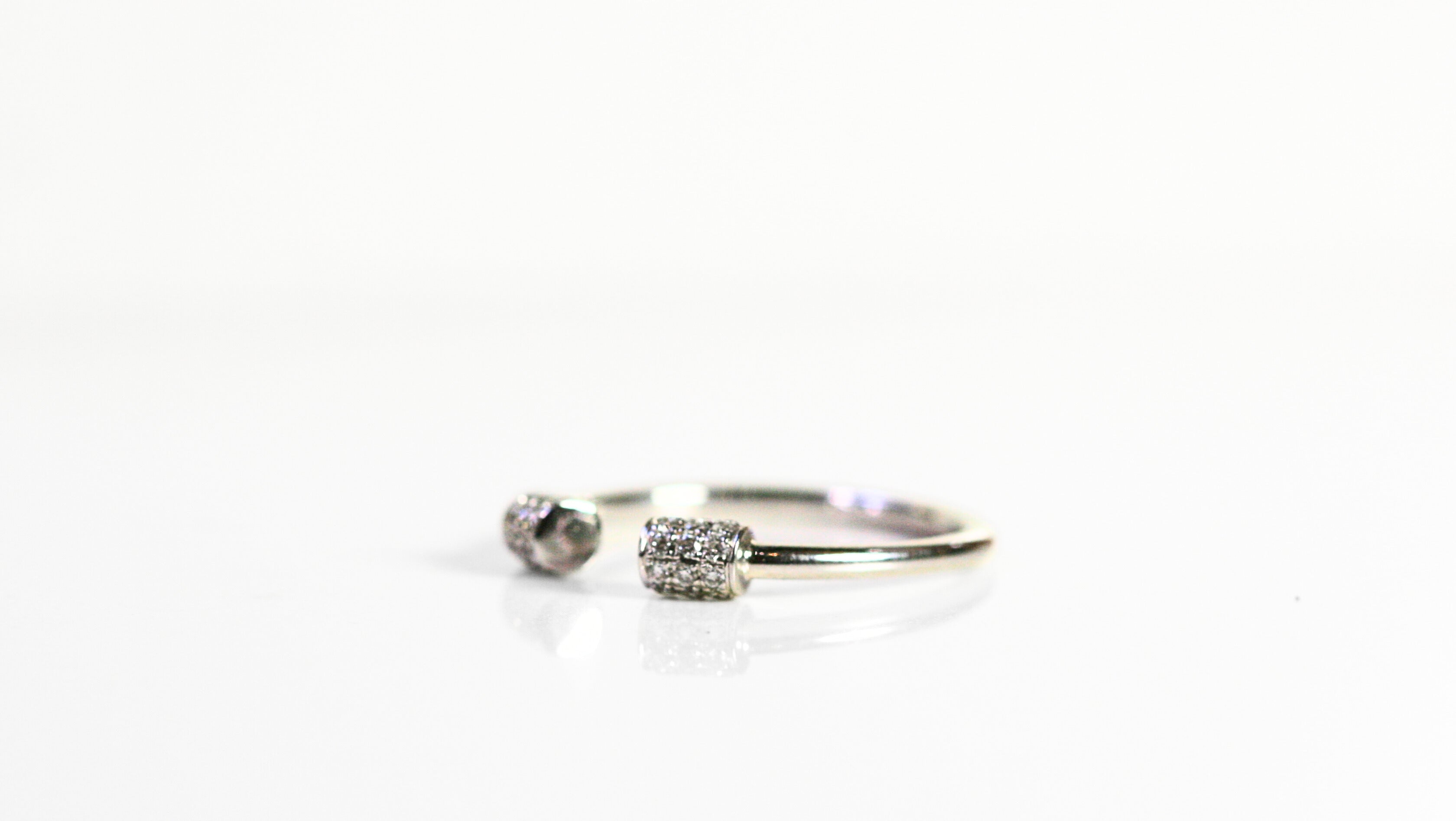 18k white gold ring. Cylinders covered in diamonds meet at the center of the finger, leaving a blank space open at the front of the ring. Diamonds are pave set. SF jewelry, local jeweler, luxury, fine jewelry, bay area, handmade, gift for her, birthday gift, anniversary gift