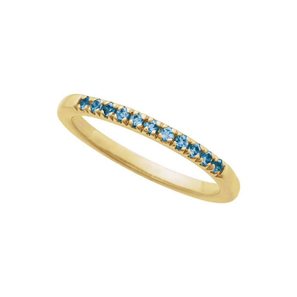 Gold ring with blue london topaz stones on a white background