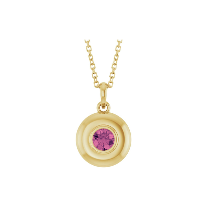 Gold necklace with a pink tourmaline pendant on a white background