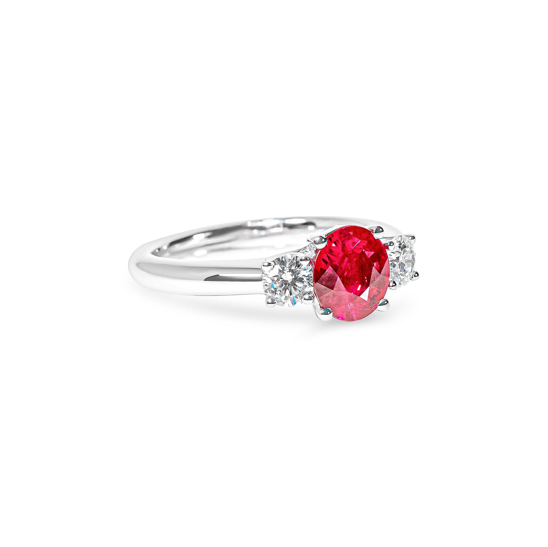 Platinum ring with a red ruby and diamonds on a white background
