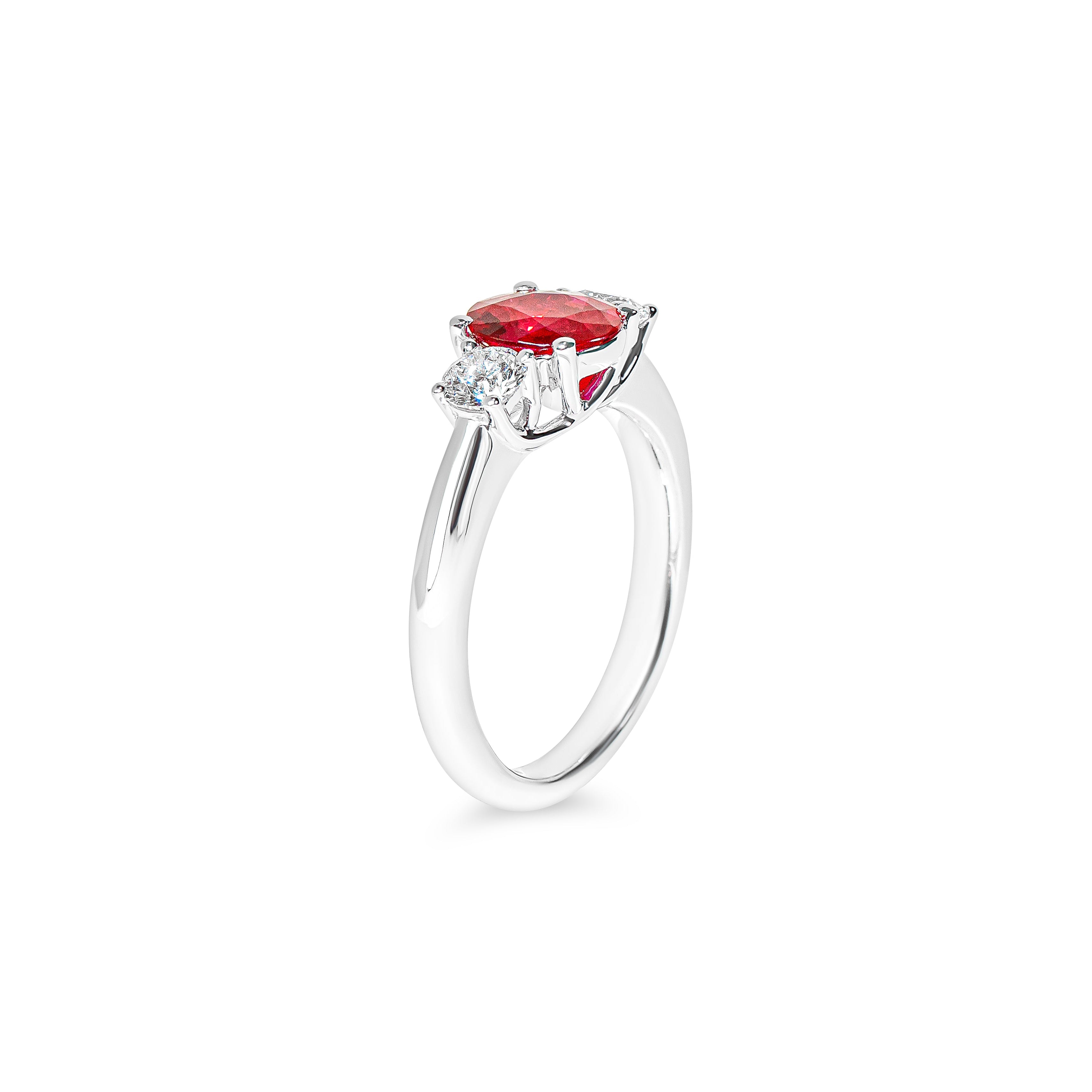 Platinum ring with a red ruby and diamonds on a white background