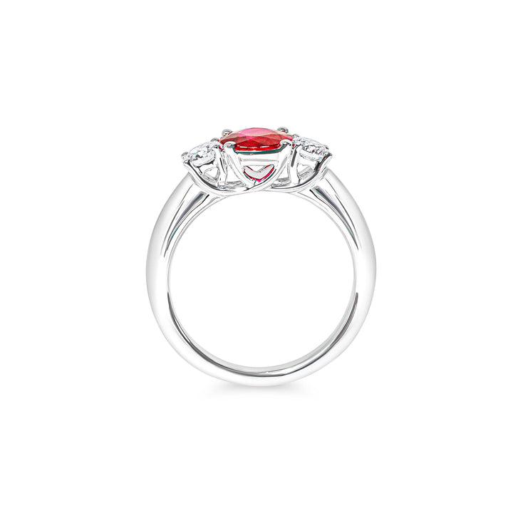 Platinum ring with a red ruby and diamonds on a white background