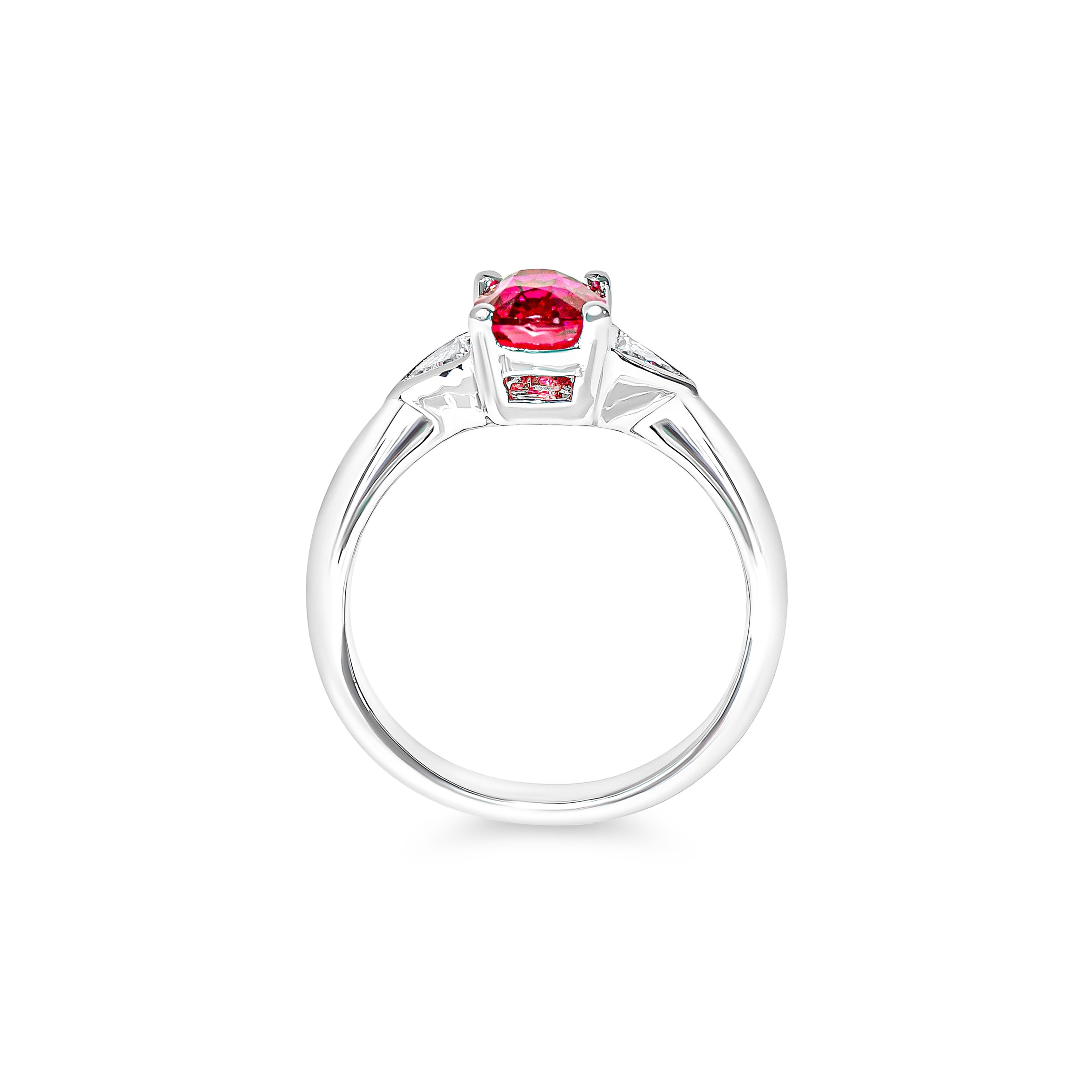 Platinum ring with a red ruby and two trillion diamonds on a white background