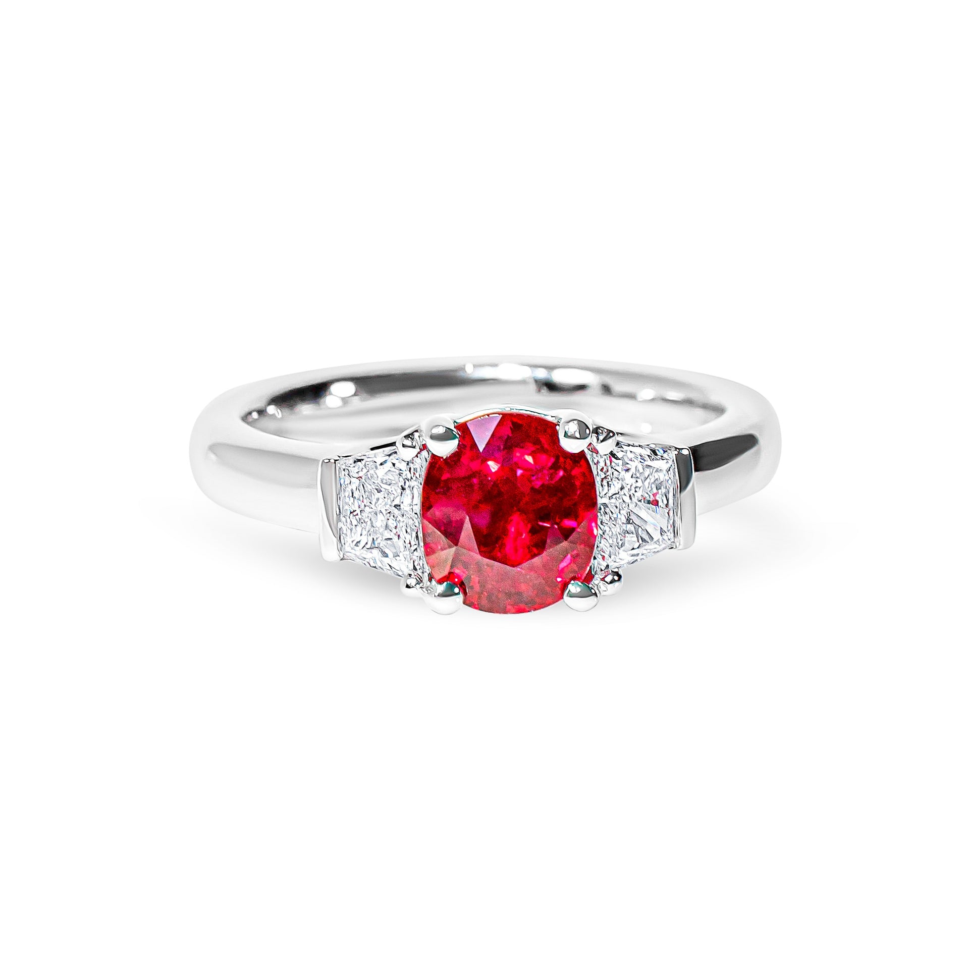 Platinum ring with a red ruby and diamond accents on a white background