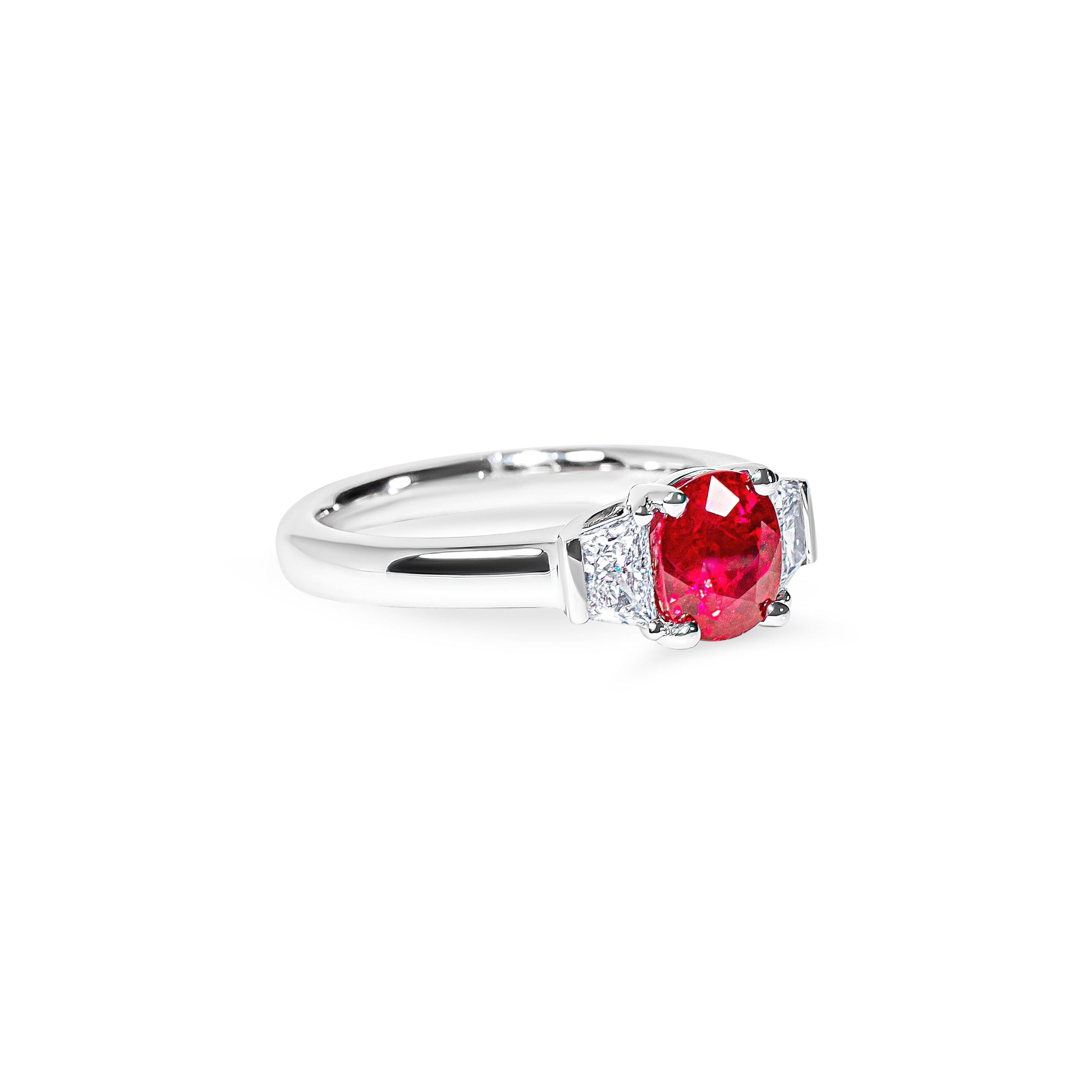 Platinum ring with a red ruby and diamond accents on a white background