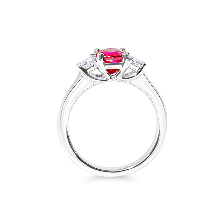 Platinum ring with a red ruby and diamond accents on a white background