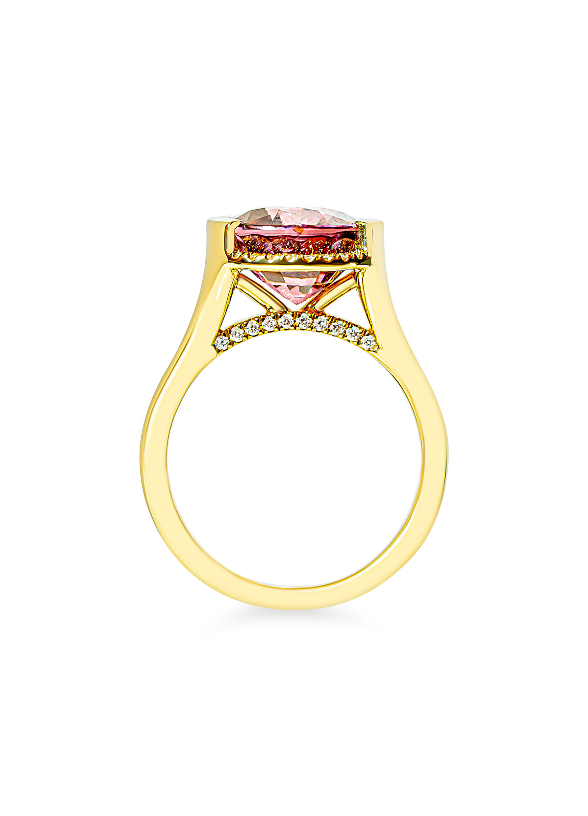 A yellow gold ring featuring a pink gemstone in a half-bezel setting, accented by small diamonds along the bridge, shown on a plain white background.
