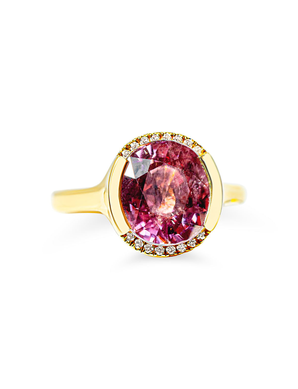 A yellow gold ring featuring a large oval berry pink tourmaline surrounded by a partial halo of diamonds, set against a plain white background.