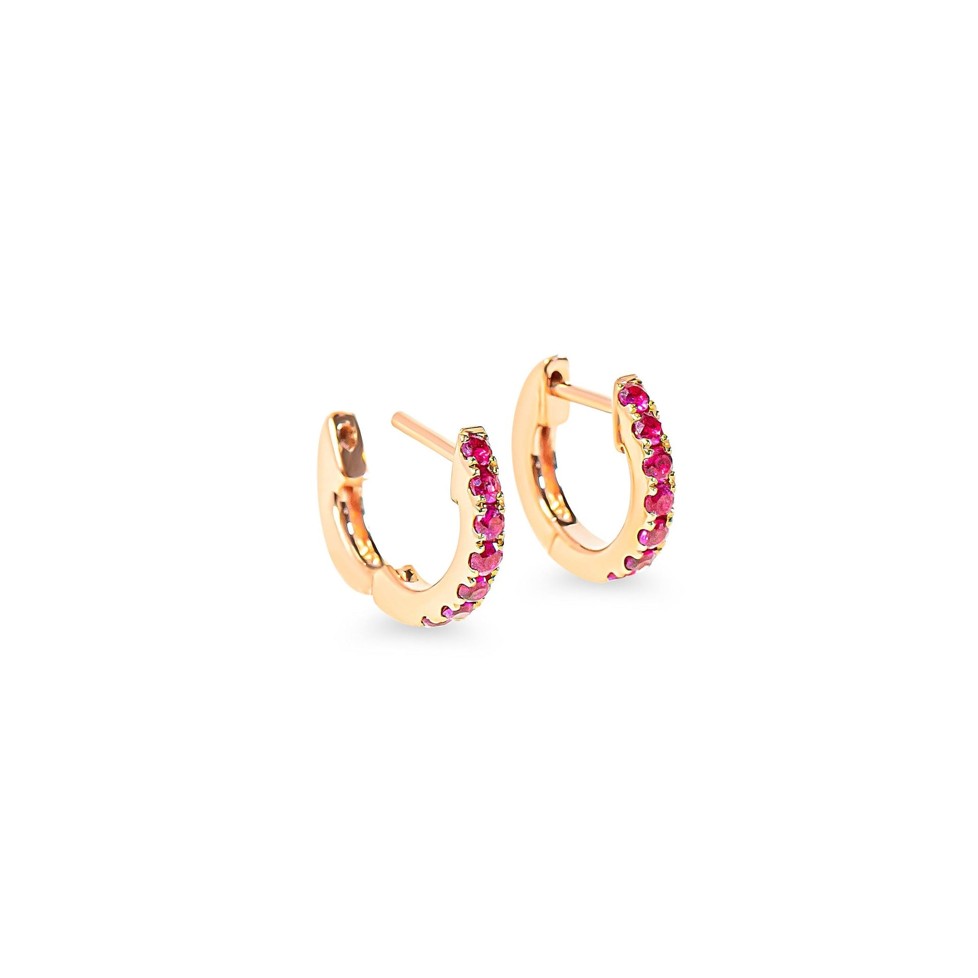 Rose gold hoop earrings with red-pink rubies on a white background