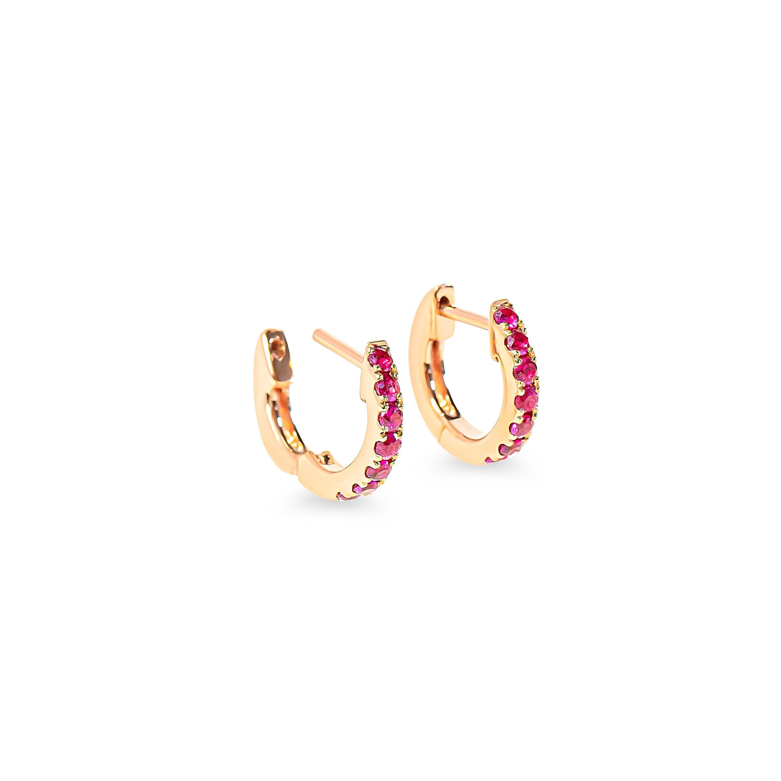 Rose gold hoop earrings with red-pink rubies on a white background