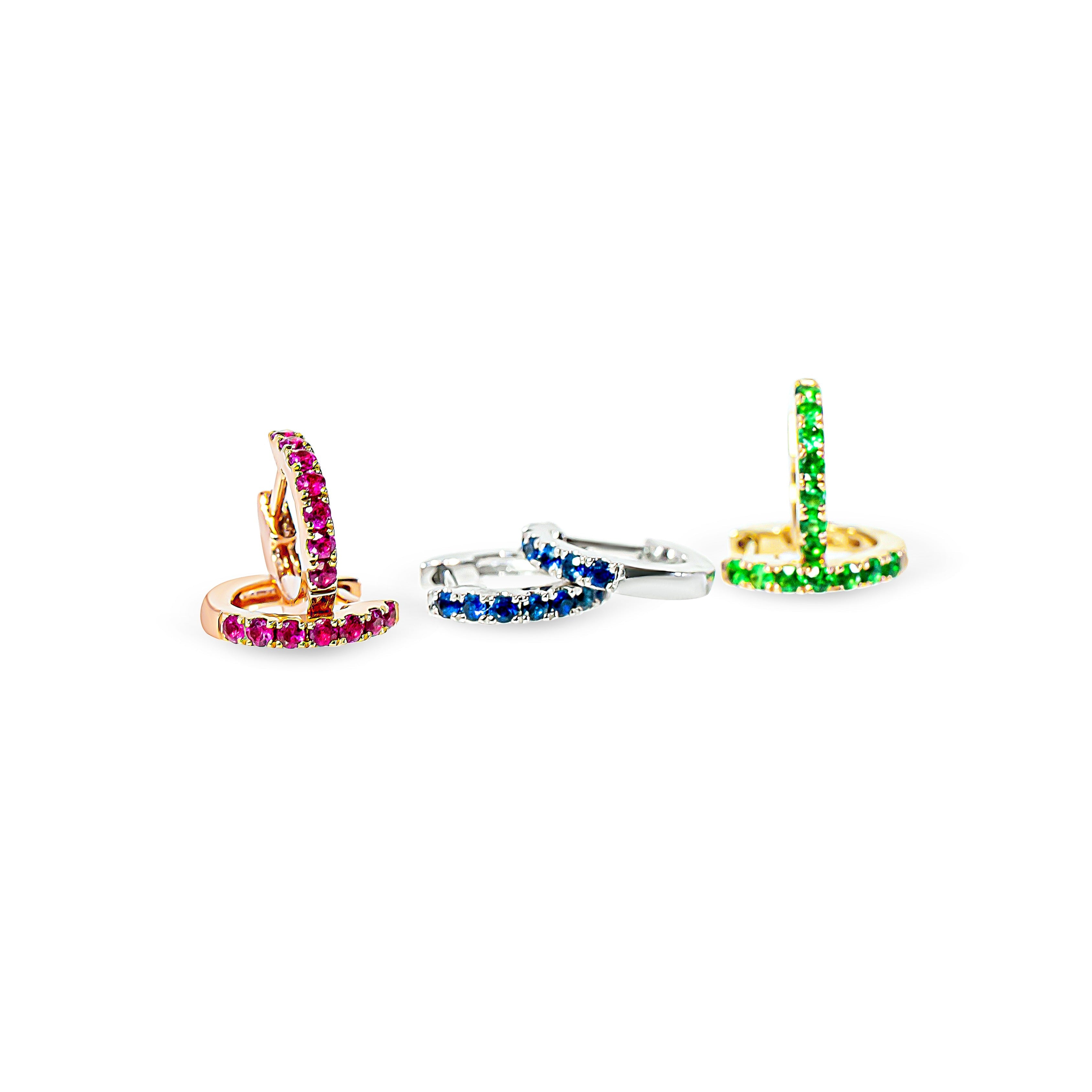 Three colorful hoop earrings on a white background