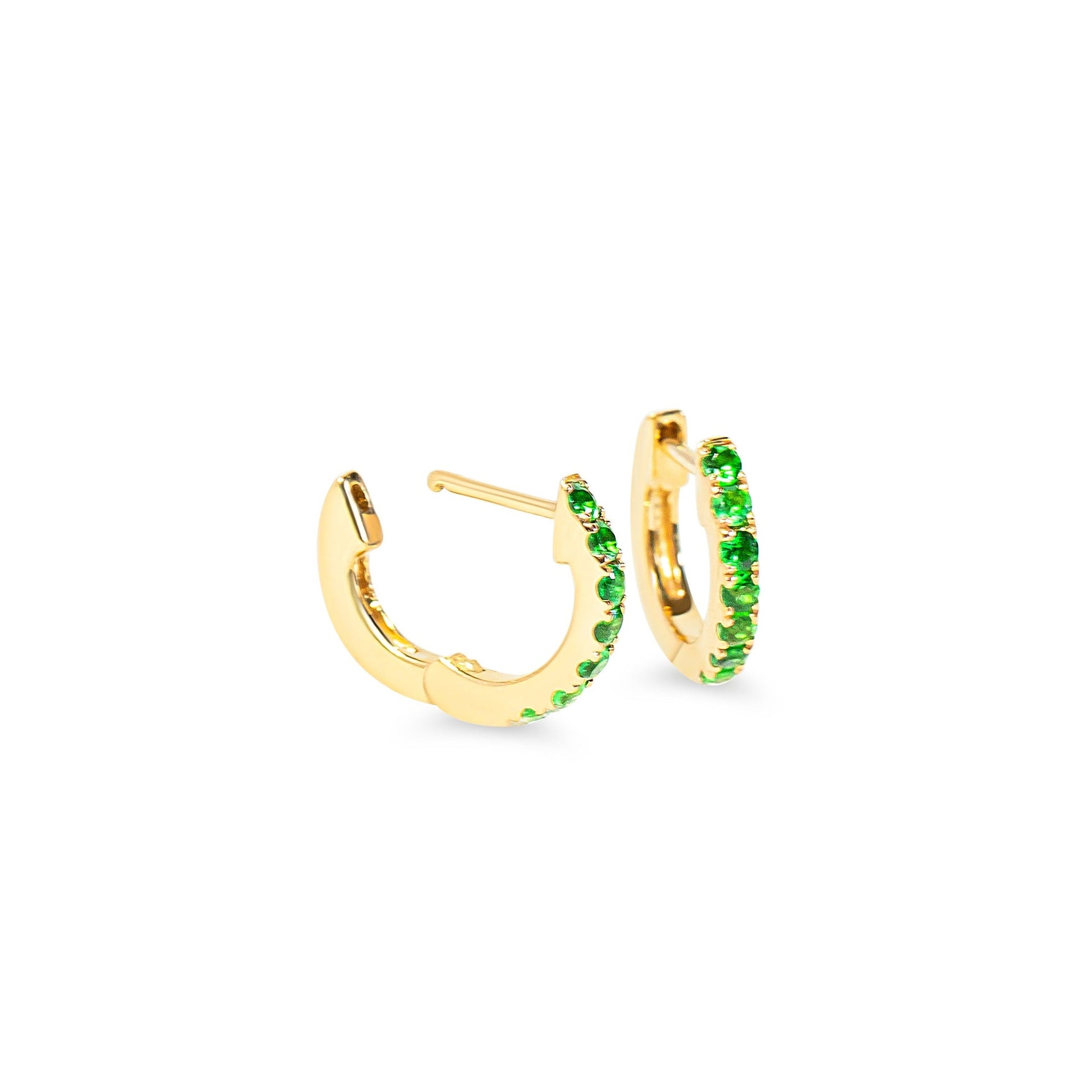 Gold huggie hoop earrings with green tsavorite garnet on a white background