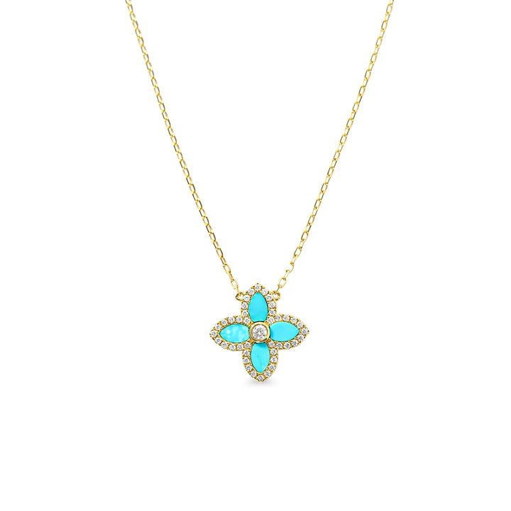 Gold necklace with a turquoise clover pendant with diamonds on a white background