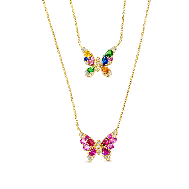 Butterfly-shaped necklaces with colorful gemstones on gold chains against a white background