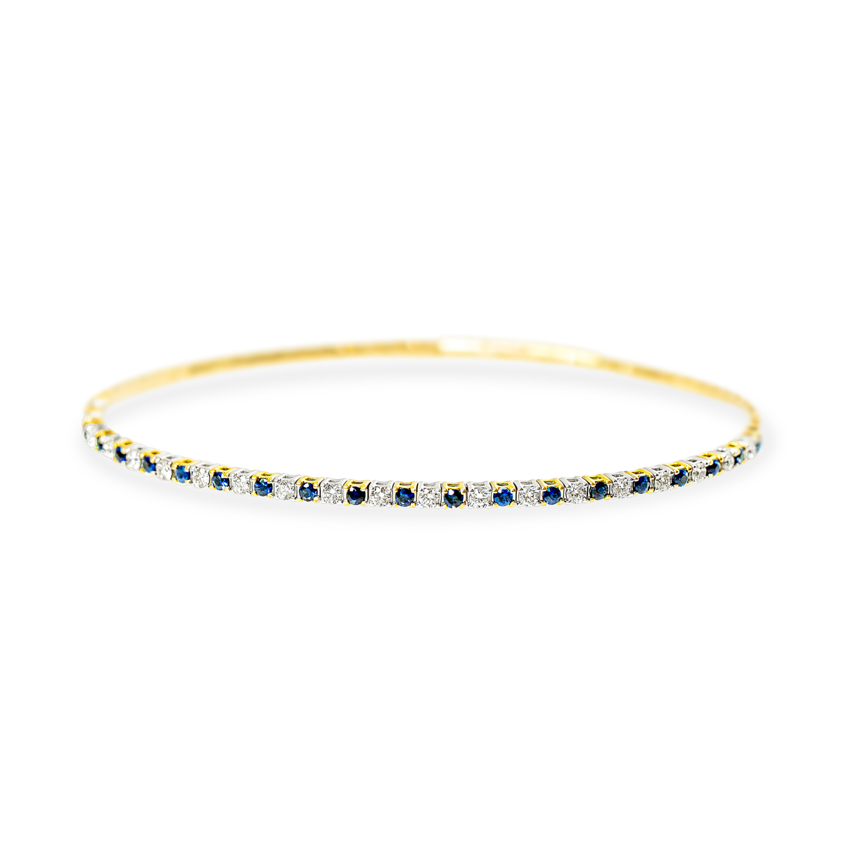 A dainty gold bangle bracelet featuring a continuous row of round-cut blue sapphires and white diamonds, set against a plain white background.
